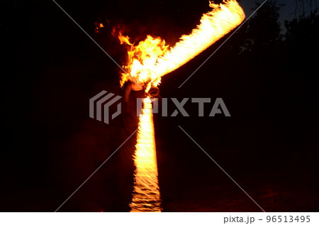 fire show, dancing with flame, male master fakir with fire works, performance outdoors fire show, dancing with flame, male master fakir with fire works, performance outdoors 96513495