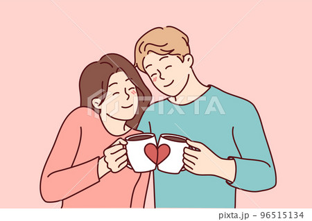Happy couple hug drink coffee from cute cups 96515134