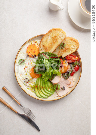 Fried eggs breakfast with salad and avocado 96518400