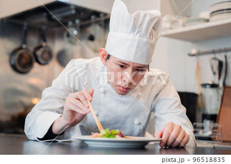 料理の盛り付けをする男性シェフ 料理の盛り付けをする男性シェフ 96518835