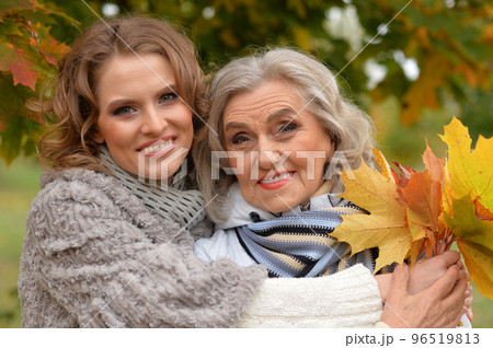 Portrait of an elderly woman with her daughter in autumn. Portrait of an elderly woman with her daughter in autumn. 96519813