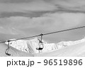 Chair lift at ski resort. Black and white high mountains in winter. 96519896