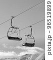 Black and white chair lifts and snowy winter high mountains 96519899
