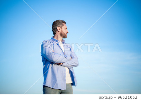 pensive caucasian man standing peaceful, copy space. pensive man in shirt outdoor. pensive man pensive caucasian man standing peaceful, copy space. pensive man in shirt outdoor. pensive man 96521052