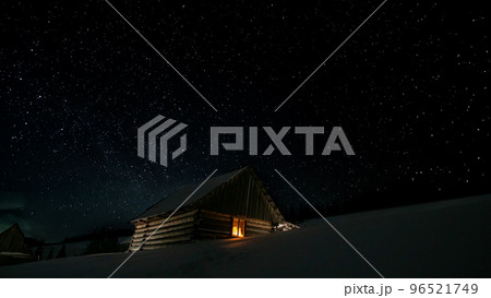 Stars in the night sky and a wooden house Stars in the night sky and a wooden house 96521749