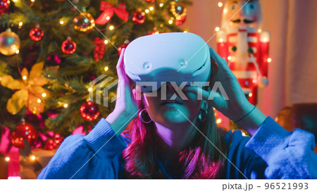 girl with VR goggles in Christmas time 96521993