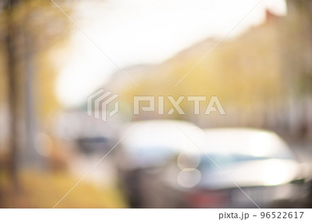 Autumn season bokeh background. Abstract city blur along the road with cars. Autumn season bokeh background. Abstract city blur along the road with cars. 96522617