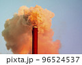 Chemical plant pipe with a toxic orange smoke moving up polluting atmosphere 96524537