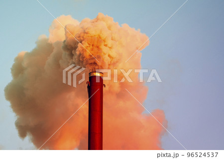 Chemical plant pipe with a toxic orange smoke moving up polluting atmosphere 96524537