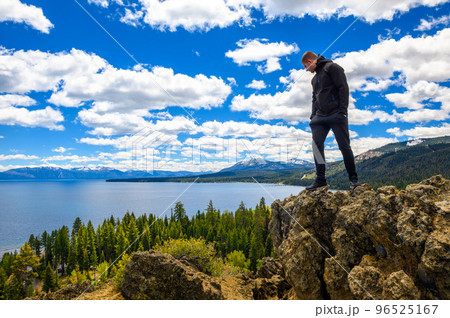 Hiker enjoying the view of Lake Tahoe from the Eagle Rock in California Hiker enjoying the view of Lake Tahoe from the Eagle Rock in California 96525167