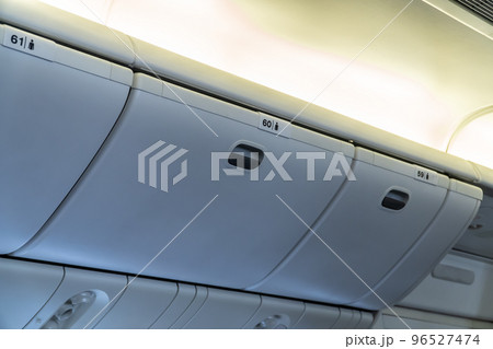Luggage overhead in the cabin No.59 60 61 in airplane Luggage overhead in the cabin No.59 60 61 in airplane 96527474
