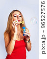 Young pretty woman with soap bubbles 96527576