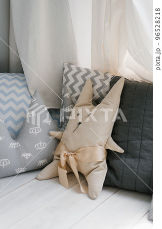 Pillow in the form of a creative bunny in a baby cot in the bedroom 96528218