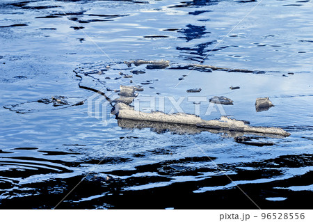 Large ice floe in blue winter water 96528556