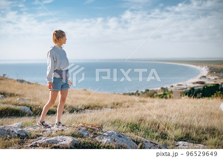 Traveller girl outdoor in park looking into the horizon 96529649