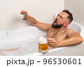 Bearded man watching football with beer in bath 96530601
