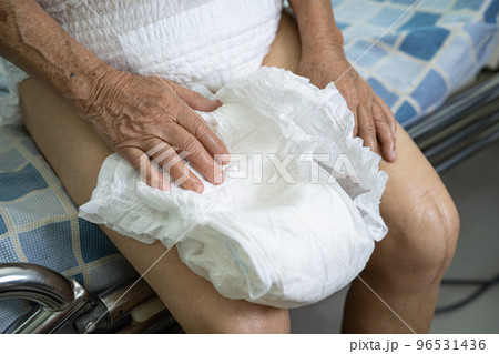 Asian senior or elderly old lady woman patient wearing incontinence diaper in nursing hospital ward, healthy strong medical concept. 96531436