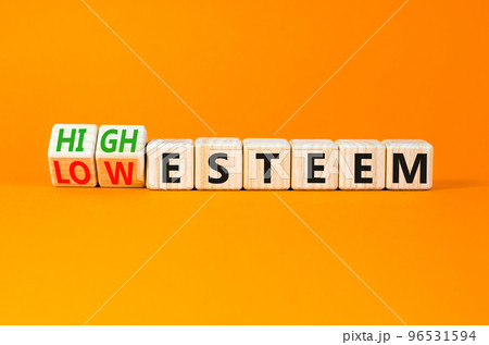 High or low esteem symbol. Concept words High esteem and Low esteem on wooden cubes. Beautiful orange table orange background. Business high or low esteem concept. Copy space. High or low esteem symbol. Concept words High esteem and Low esteem on wooden cubes. Beautiful orange table orange background. Business high or low esteem concept. Copy space. 96531594