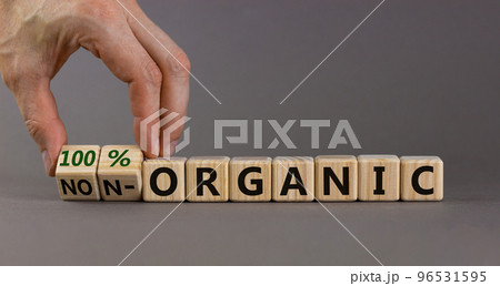 100 percent organic symbol. Fliped wooden cubes and changed words non-organic to 100 percent organic. Beautiful grey background, copy space. Business, healthy lifestyle 100 percent organic concept. 100 percent organic symbol. Fliped wooden cubes and changed words non-organic to 100 percent organic. Beautiful grey background, copy space. Business, healthy lifestyle 100 percent organic concept. 96531595
