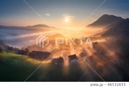 Aerial view of mountain village in orange low clouds at sunrise 96532655