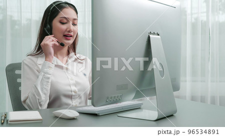 Enthusiastic female operator provide helpful customer service to customer. 96534891