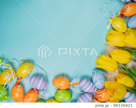 Bouquet of spring yellow tulips and colorful easter eggs on a blue background Bouquet of spring yellow tulips and colorful easter eggs on a blue background 96536825