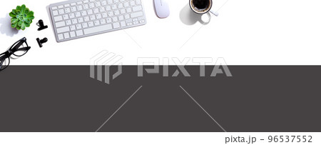 Computer keyboard with a cup of coffee and eyeglasses Computer keyboard with a cup of coffee and eyeglasses 96537552