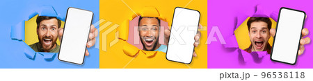 Three excited young multicultural men holding three big cell phones 96538118
