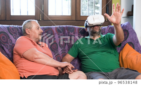 Homosexual couple playing VR game Homosexual couple playing VR game 96538148