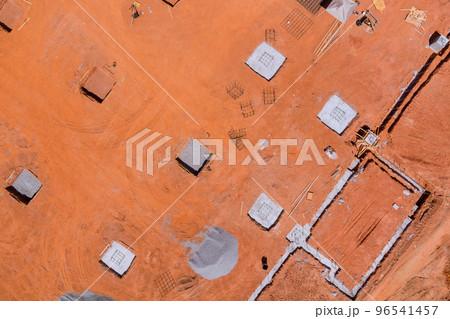 During large construction site, trenches are being prepared for pouring concrete to foundations 96541457