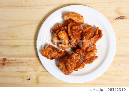 Fried Pork Skins With Red Salsa in Plate on Wooden Table Fried Pork Skins With Red Salsa in Plate on Wooden Table 96542310