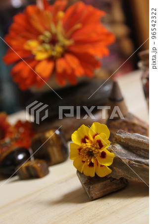 Flowers and Incense Cone With Palo Santo Sticks on Meditation Table Flowers and Incense Cone With Palo Santo Sticks on Meditation Table 96542322