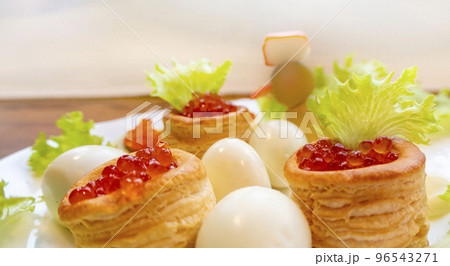 Closeup of caviar and cream cheese appetizer on crackers 96543271