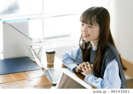 パソコン向かって働く若い女性 96543681