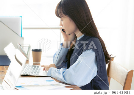 オフィスで通話する若い女性 オフィスで通話する若い女性 96543982
