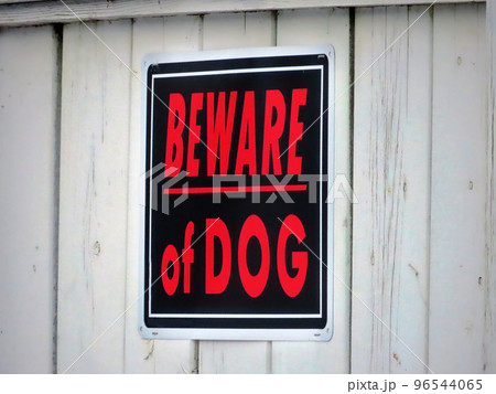 A white wooden fence with a sign with the text A white wooden fence with a sign with the text 96544065