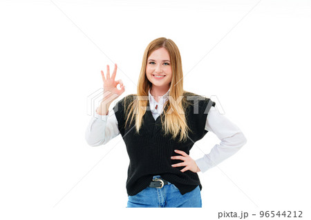 a blonde in a black vest shows an ok sign from the fingers on a white background a blonde in a black vest shows an ok sign from the fingers on a white background 96544212