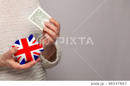 Flag of UK on money bank in English woman hands 96547667