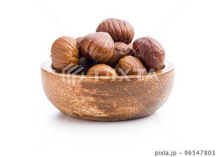 Peeled chestnuts. Sweet roasted chestnuts in bowl isolated on white background. Peeled chestnuts. Sweet roasted chestnuts in bowl isolated on white background. 96547803