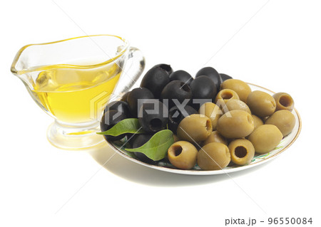 Jug with olive oil, green and black olives isolated on white background Jug with olive oil, green and black olives isolated on white background 96550084