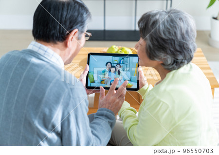 オンラインで娘夫婦と通話するシニアの夫婦 96550703