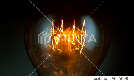 Close-up of shining vintage light bulb, dark background Close-up of shining vintage light bulb, dark background 96550909
