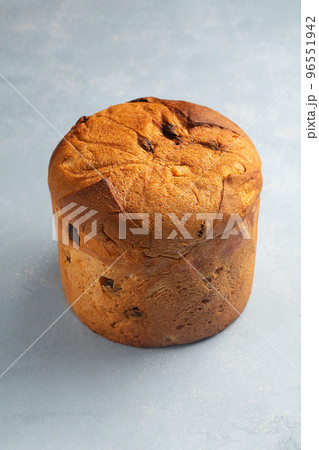 One panettone sweet bread , traditional Italian food for Christmas on a blue background One panettone sweet bread , traditional Italian food for Christmas on a blue background 96551942