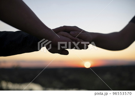 People's hands are stacked on top of each other for team development and team building against the background of the sunset sky. The concept of unity, mutual support and mutual assistance People's hands are stacked on top of each other for team development and team building against the background of the sunset sky. The concept of unity, mutual support and mutual assistance 96553570