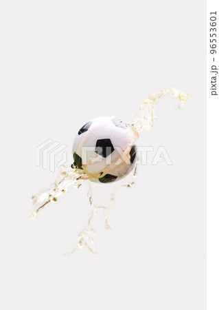 Soccer ball in beer splash on white background. 96553601
