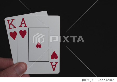 Playing cards ace of hearts and king of hearts on black 96556407