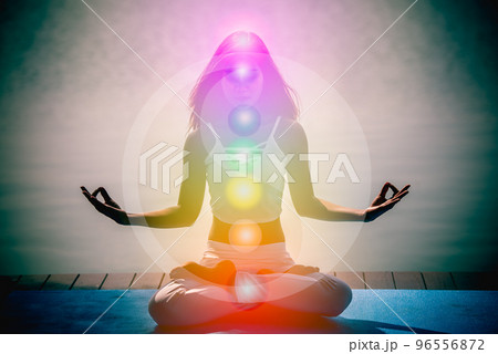 Young aura woman in yoga meditation with nature seven chakras and Yin Yang symbols. 96556872