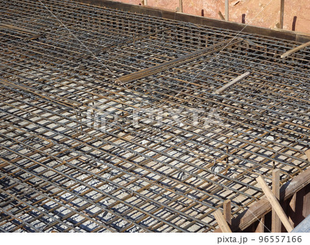MELAKA, MALAYSIA -JULY 2, 2022: Steel reinforcement bars are arranged according to the structural engineer's design. The steels are tied together using a small steel wire. 96557166