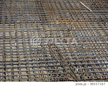MELAKA, MALAYSIA -JULY 2, 2022: Steel reinforcement bars are arranged according to the structural engineer's design. The steels are tied together using a small steel wire. 96557167
