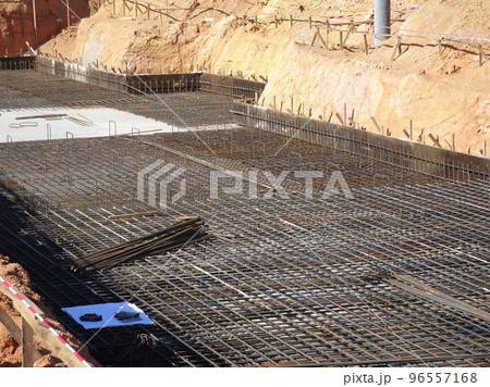 MELAKA, MALAYSIA -JULY 2, 2022: Steel reinforcement bars are arranged according to the structural engineer's design. The steels are tied together using a small steel wire. 96557168